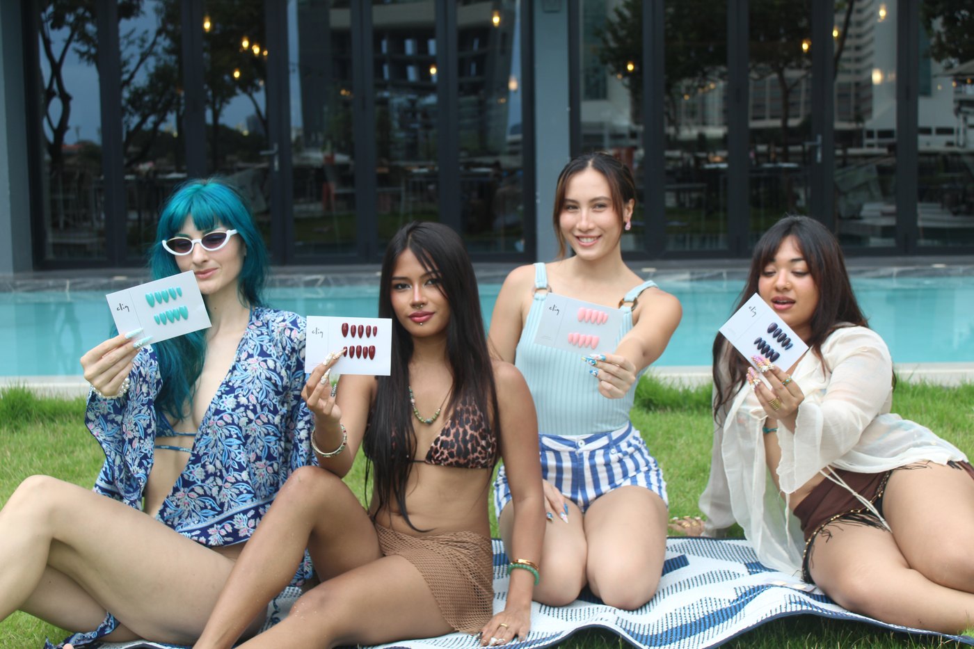 All 4 muses on Bangkok lawn with custom CLIQ signature cards