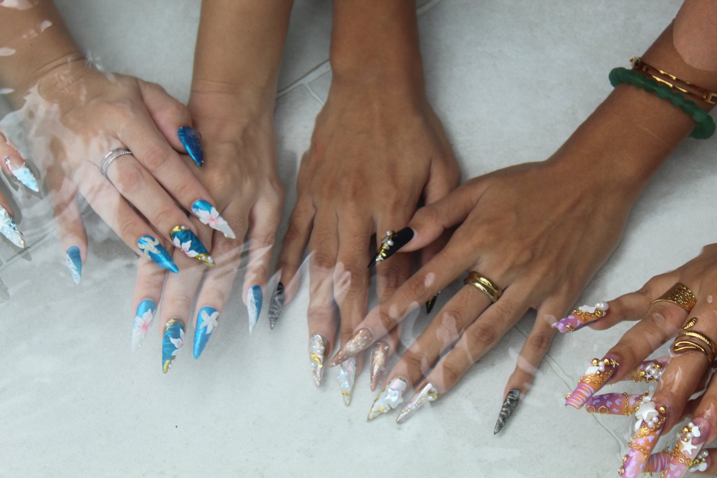 Multi-hand water circle in pool with waterproof CLIQ nails